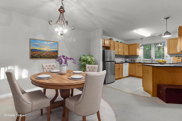 91 Potawatomi Rd Unit N-2, Williams Bay, WI 53191 - dining area featuring a chandelier and baseboards