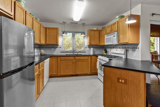 91 Potawatomi Rd Unit N-2, Williams Bay, WI 53191 - kitchen featuring white appliances, a sink, dark countertops, a peninsula, and decorative backsplash
