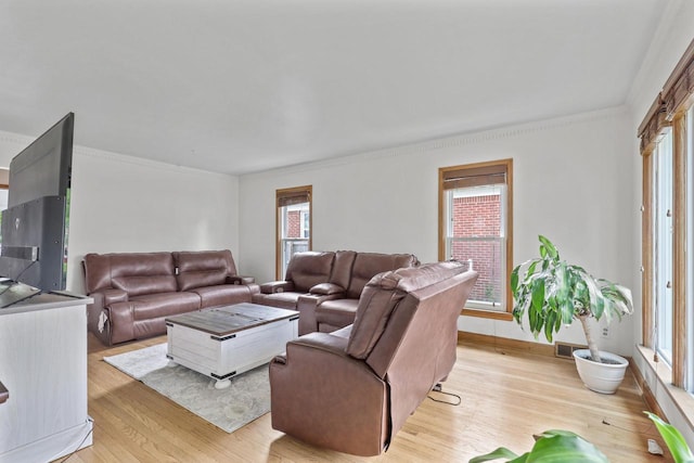 3612 N 57th St, Milwaukee, WI 53216 - living room featuring light wood finished floors, crown molding, and baseboards