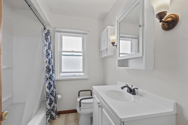 3612 N 57th St, Milwaukee, WI 53216 - full bathroom featuring toilet, vanity, wood finished floors, baseboards, and shower / bathtub combination with curtain