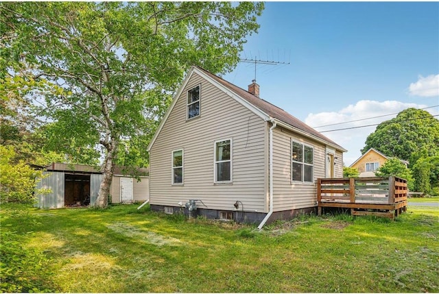201 5th St, Centuria, WI 54824 - rear view of property with a deck, a yard, and a chimney