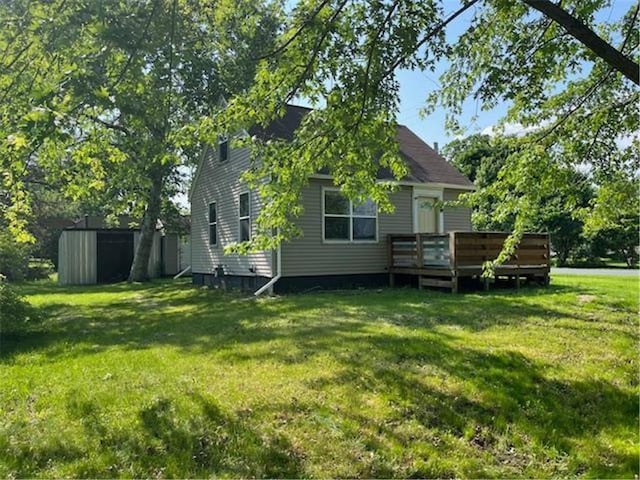 201 5th St, Centuria, WI 54824 - view of side of property featuring a wooden deck and a lawn