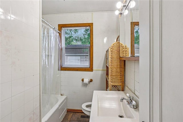 201 5th St, Centuria, WI 54824 - full bath with tile walls, toilet, shower / tub combo with curtain, and vanity