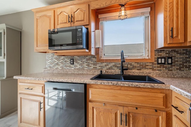 2759 Hamilton St, Oshkosh, WI 54901 - kitchen featuring dishwasher, a sink, backsplash, and light countertops