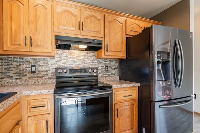 2759 Hamilton St, Oshkosh, WI 54901 - kitchen featuring stainless steel appliances, under cabinet range hood, and decorative backsplash