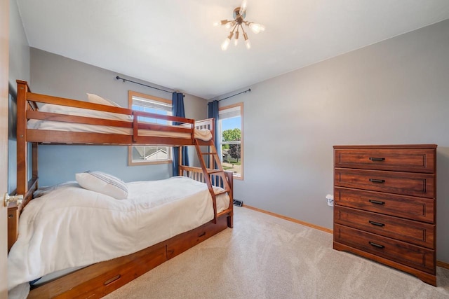 2759 Hamilton St, Oshkosh, WI 54901 - bedroom featuring a chandelier, baseboards, and carpet flooring