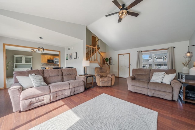 2759 Hamilton St, Oshkosh, WI 54901 - living room with stairs, ceiling fan, vaulted ceiling, wood finished floors, and a chandelier