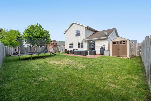 2759 Hamilton St, Oshkosh, WI 54901 - rear view of property with a trampoline, outdoor lounge area, and a patio