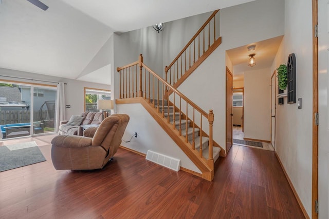 2759 Hamilton St, Oshkosh, WI 54901 - living area featuring wood finished floors, stairs, baseboards, and high vaulted ceiling