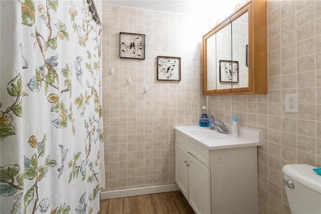 1843 190th St, Centuria, WI 54824 - full bathroom featuring tile walls, vanity, toilet, wood finished floors, and a shower with curtain