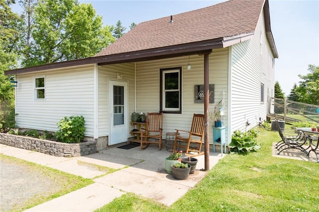 1843 190th St, Centuria, WI 54824 - rear view of house featuring roof with shingles and a patio area