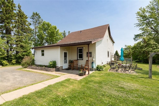 1843 190th St, Centuria, WI 54824 - view of front of home with a front yard, a patio, and a shingled roof