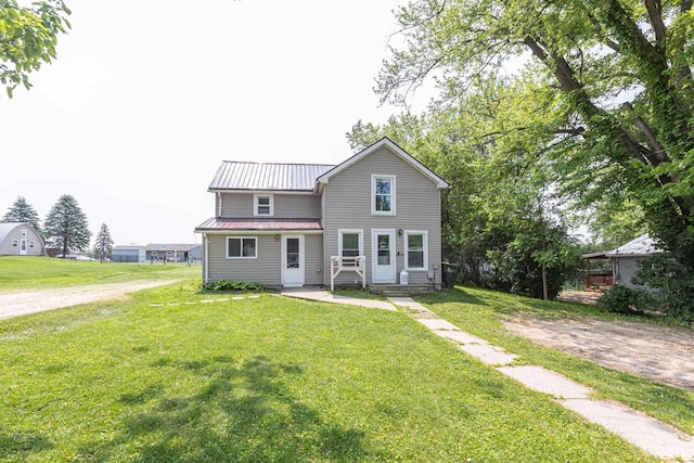 811 E Maple St, Lancaster, WI 53813 - traditional-style home featuring a front lawn and metal roof