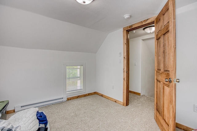 811 E Maple St, Lancaster, WI 53813 - additional living space featuring baseboard heating, vaulted ceiling, light carpet, and baseboards
