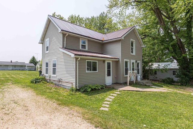 811 E Maple St, Lancaster, WI 53813 - traditional-style house featuring a front lawn and metal roof