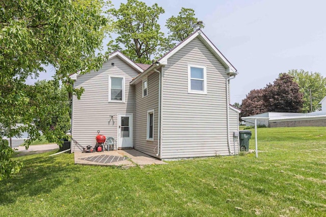 811 E Maple St, Lancaster, WI 53813 - rear view of house featuring a lawn and a patio