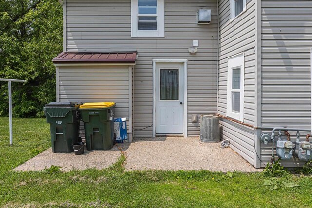 811 E Maple St, Lancaster, WI 53813 - rear view of house featuring a yard, a patio, a standing seam roof, metal roof, and central AC