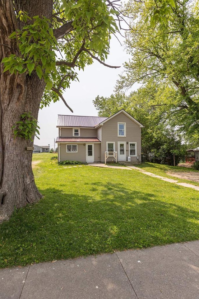 811 E Maple St, Lancaster, WI 53813 - view of front of house featuring a front yard and metal roof