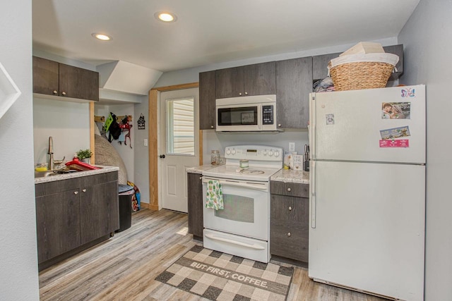 811 E Maple St, Lancaster, WI 53813 - kitchen with white appliances, dark brown cabinetry, light wood-type flooring, light countertops, and recessed lighting