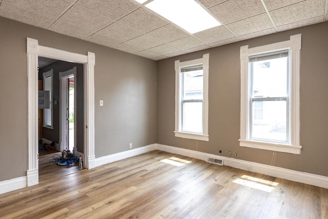 912 N Richmond St, Appleton, WI 54911 - empty room with baseboards, a drop ceiling, and light wood-style floors