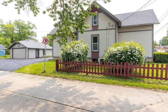 912 N Richmond St, Appleton, WI 54911 - view of front facade with a garage, an outdoor structure, and a shingled roof
