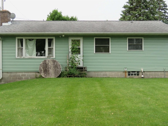 N10380 Howard Dr, Fox Lake, WI 53933 - rear view of house featuring a lawn, entry steps, and a shingled roof