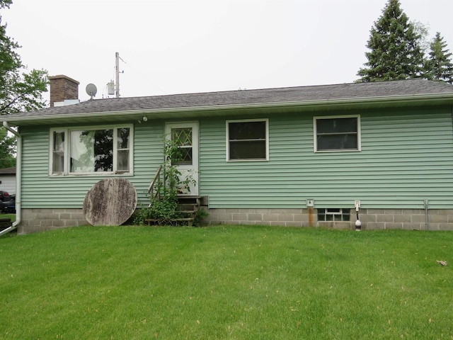 N10380 Howard Dr, Fox Lake, WI 53933 - rear view of house with a lawn and a chimney