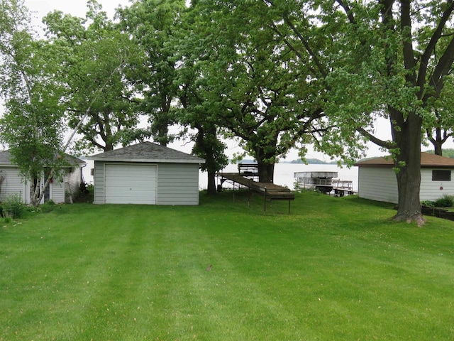 N10380 Howard Dr, Fox Lake, WI 53933 - view of grassy yard featuring an outdoor structure and a detached garage