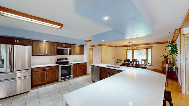 202602 County Road T, Marshfield, WI 54449 - kitchen with appliances with stainless steel finishes, a sink, light countertops, a kitchen breakfast bar, and recessed lighting