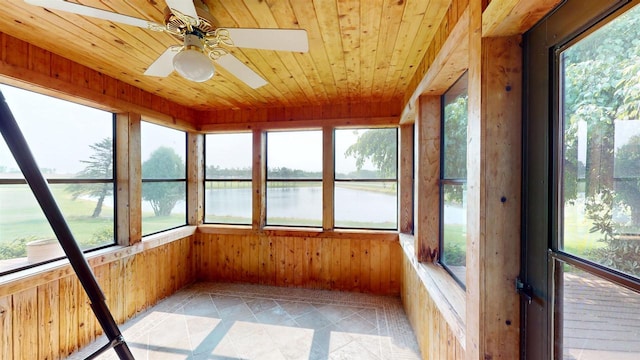 202602 County Road T, Marshfield, WI 54449 - unfurnished sunroom with a water view, plenty of natural light, a ceiling fan, wooden walls, and wooden ceiling