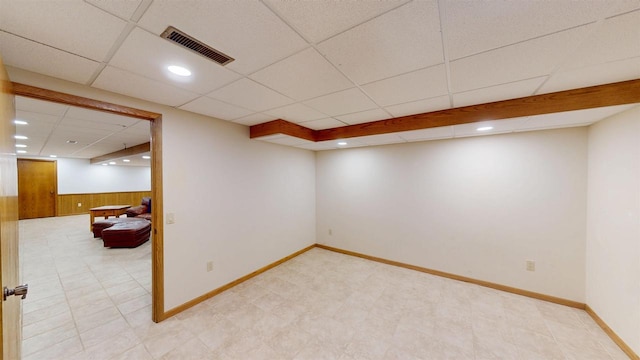 202602 County Road T, Marshfield, WI 54449 - finished below grade area featuring a drop ceiling, wood walls, baseboards, and a wainscoted wall