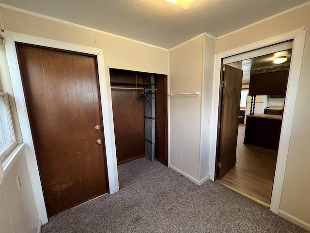 856 8th St, Beloit, WI 53511 - unfurnished bedroom with ornamental molding, carpet flooring, baseboards, multiple windows, and multiple closets
