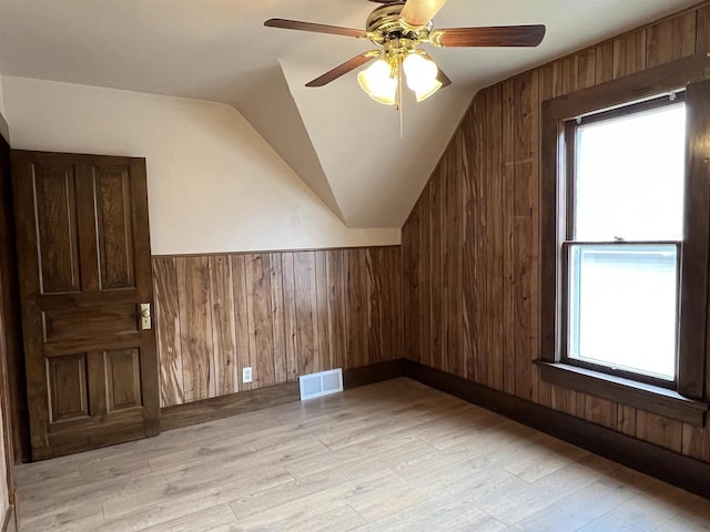 856 8th St, Beloit, WI 53511 - bonus room with lofted ceiling, wood walls, light wood-type flooring, a ceiling fan, and plenty of natural light