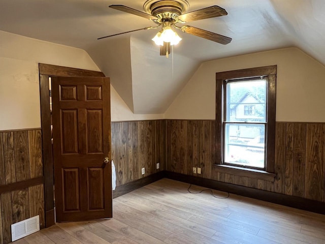856 8th St, Beloit, WI 53511 - bonus room featuring a wainscoted wall, vaulted ceiling, light wood-style flooring, ceiling fan, and wood walls
