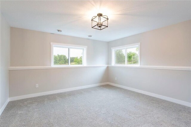 415 Moelter Ln, Hudson, WI 54016 - carpeted spare room featuring a chandelier and baseboards