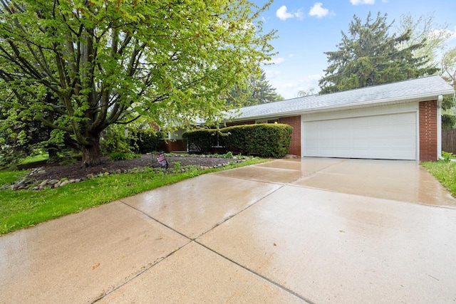 1001 W Fairfield Ct, Glendale, WI 53217 - view of front facade with concrete driveway, an attached garage, and brick siding