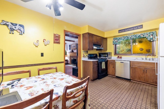 1001 W Fairfield Ct, Glendale, WI 53217 - kitchen featuring appliances with stainless steel finishes, light countertops, a ceiling fan, under cabinet range hood, and a sink