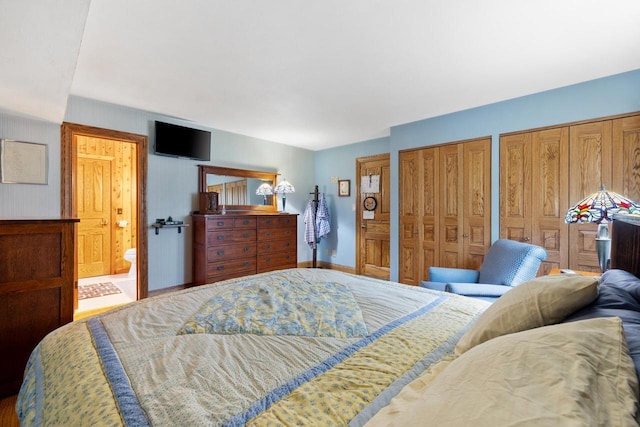 1001 W Fairfield Ct, Glendale, WI 53217 - bedroom with two closets, ensuite bath, and baseboards