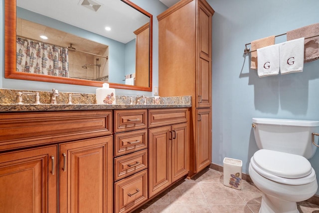 1001 W Fairfield Ct, Glendale, WI 53217 - bathroom with vanity, tiled shower, toilet, tile patterned flooring, and baseboards