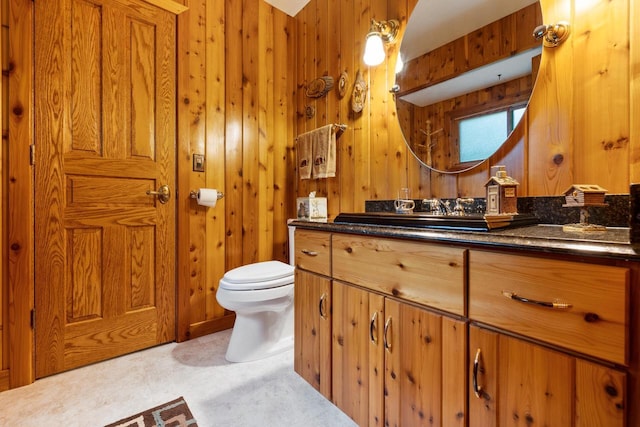 1001 W Fairfield Ct, Glendale, WI 53217 - bathroom featuring vanity, toilet, and wood walls
