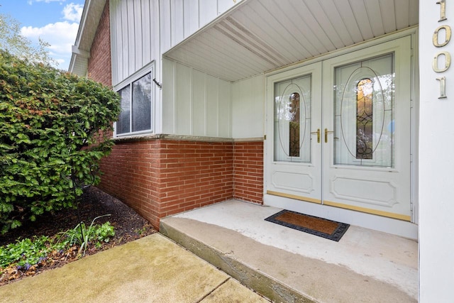 1001 W Fairfield Ct, Glendale, WI 53217 - entrance to property with board and batten siding, brick siding, and french doors