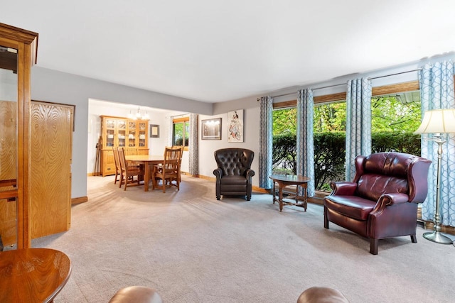 1001 W Fairfield Ct, Glendale, WI 53217 - carpeted living room featuring a chandelier and baseboards