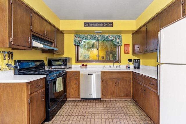 1001 W Fairfield Ct, Glendale, WI 53217 - kitchen featuring stainless steel appliances, under cabinet range hood, a sink, and light countertops