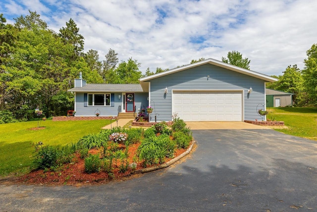 9432 James Ave, Sparta, WI 54656 - view of front of property featuring a front lawn, driveway, a chimney, and a garage