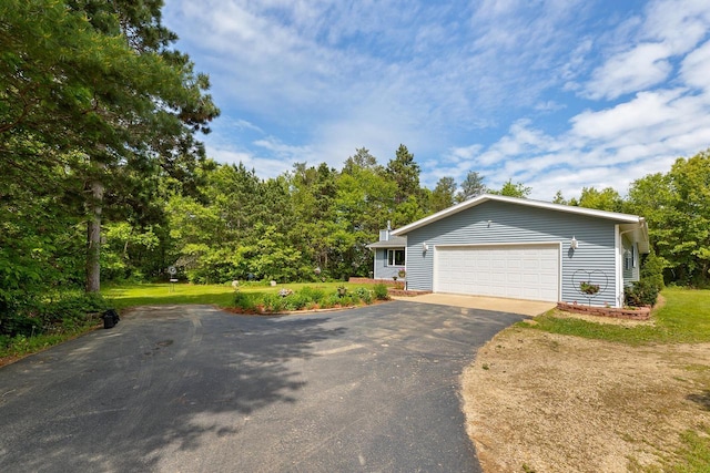 9432 James Ave, Sparta, WI 54656 - view of front of home featuring driveway, a garage, and a front lawn