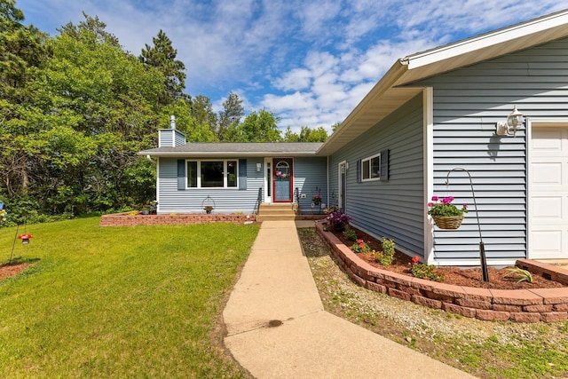 9432 James Ave, Sparta, WI 54656 - view of front of house featuring a front lawn, a garage, and a chimney