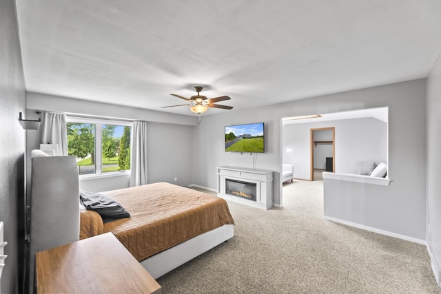 S38W32310 Green Briar Rd, Waukesha, WI 53189 - carpeted bedroom featuring baseboards, a glass covered fireplace, and ceiling fan