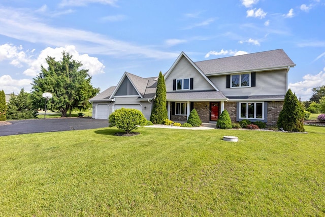 S38W32310 Green Briar Rd, Waukesha, WI 53189 - view of front facade with a garage, driveway, a front yard, and brick siding