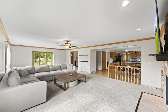 S38W32310 Green Briar Rd, Waukesha, WI 53189 - living room with crown molding, ceiling fan, a stone fireplace, baseboards, and light carpet