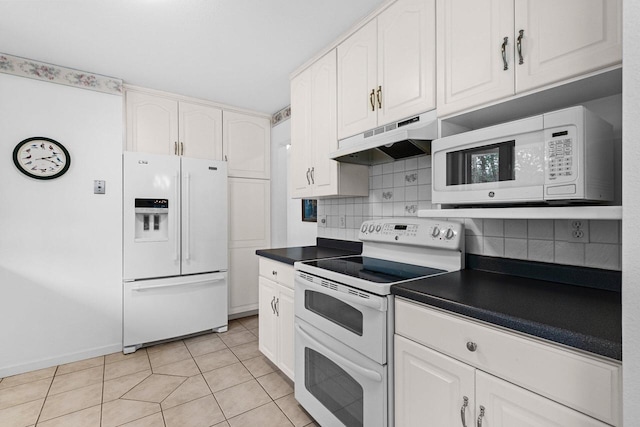 1305 Mahogany Run, Two Rivers, WI 54241 - kitchen featuring white appliances, under cabinet range hood, dark countertops, white cabinets, and decorative backsplash